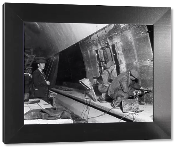 Workman lining the new Mersey Tunnel with glass. This tunnel is probably The