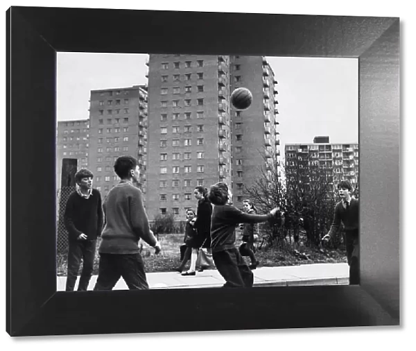 Children playing football in the street in Childwall valley housing estate, Liverpool