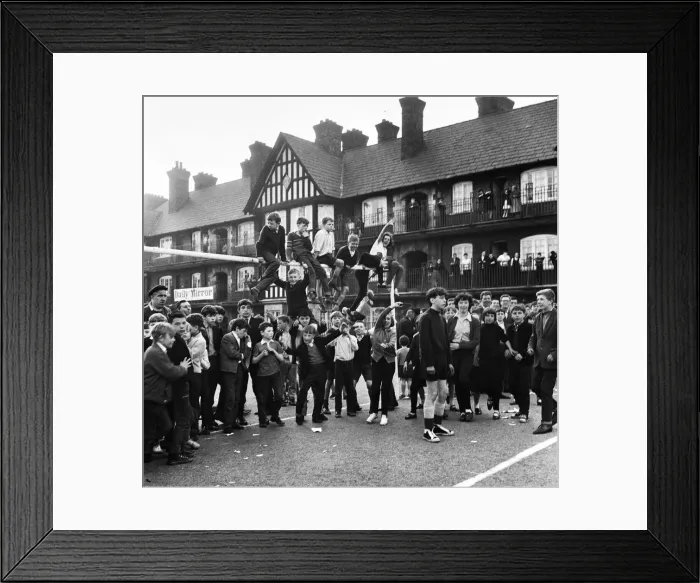 Framed Print : Young football fans sits on top of the crossbar following the conclusion of the Eldon Framed Print : Young football fans sits on top of the crossbar following the conclusion of the Eldon