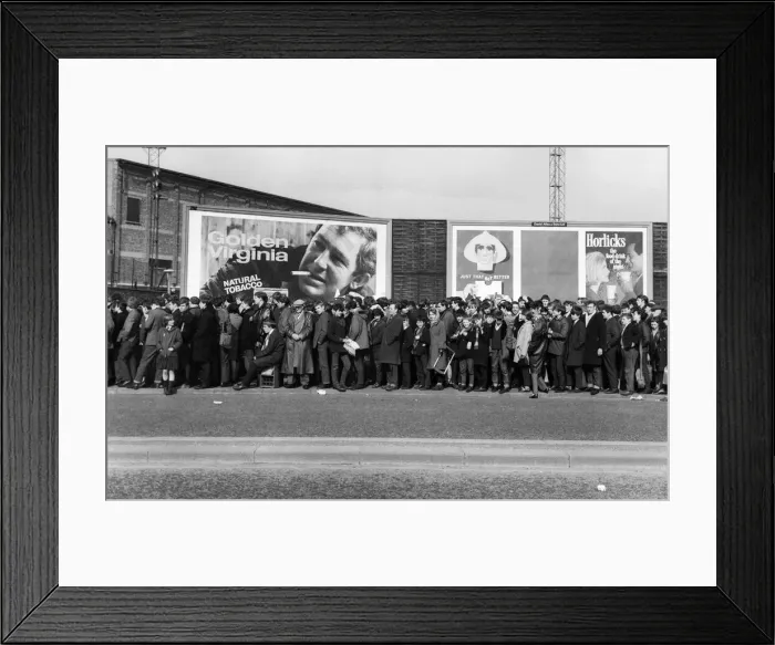 Framed Print : A long line of football fams queuing up to enter the stadium before a match in the North