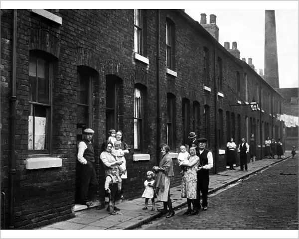 Some of the residents in a street in Pendleton, Greater Manchester. July 1932