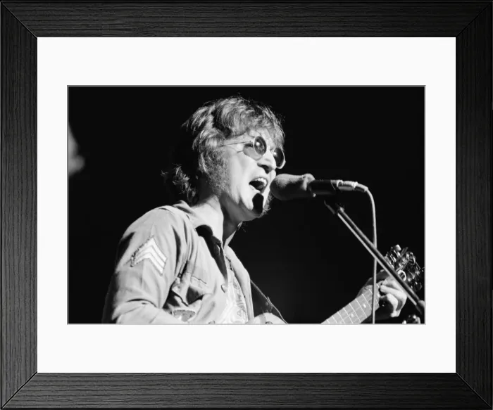 Framed Print : Former singer of The Beatles pop group John Lennon pictured performing on stage during