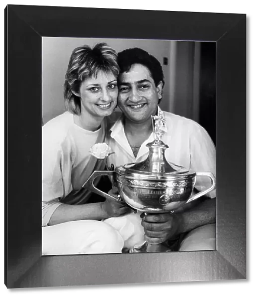 New snooker World Champion Joe Johnson holds on to the trophy with his wife Terryll