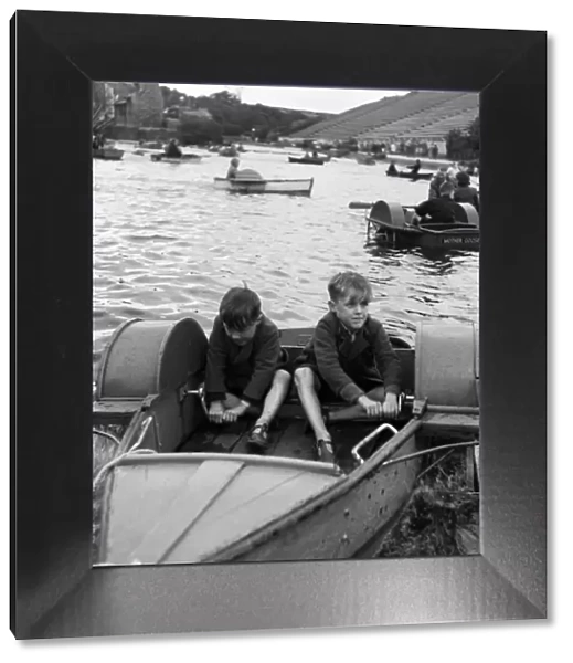 Two boys in a boat, at the boating lake at Northstead Manor Gardens in Scarborough