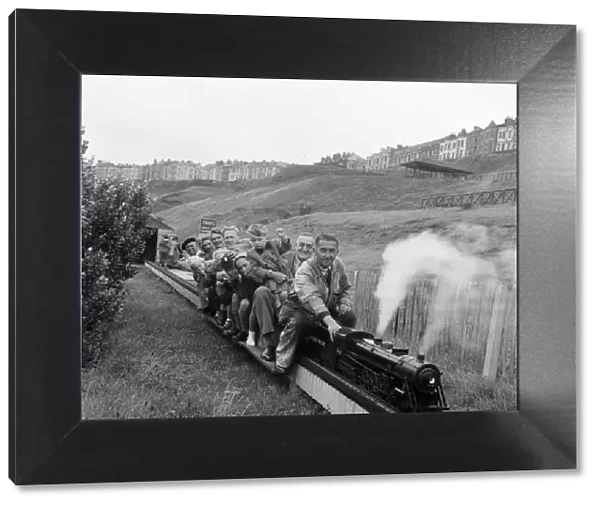 Holiday makers enjoying a ride on a miniature train. Scarborough, North Yorkshire
