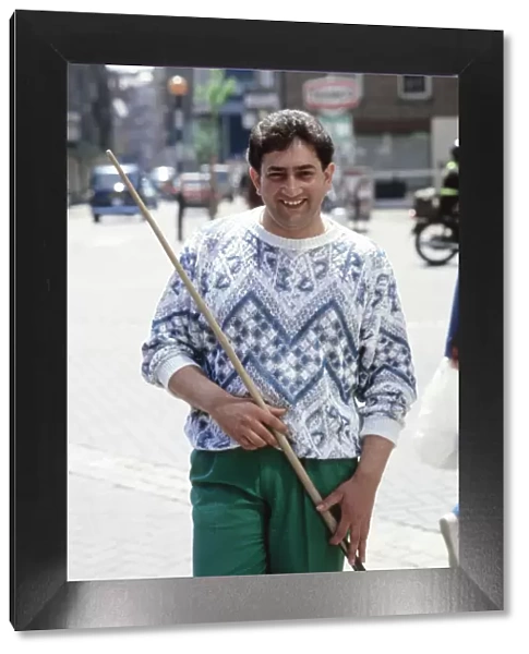 World snooker champion Joe Johnson poses with cue in the street. 28th May 1986