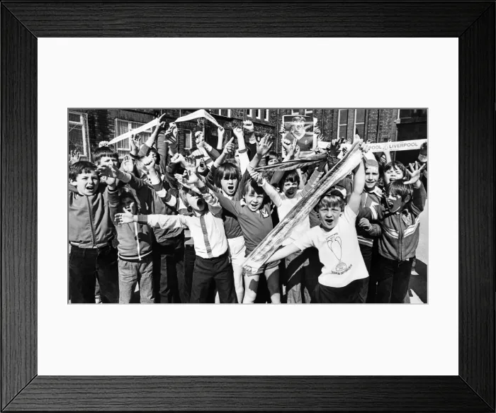 Framed Print : Wayne Ashe (right) leads the cheers from the Loyal Liverpool fans at Anfield Junior Boys Framed Print : Wayne Ashe (right) leads the cheers from the Loyal Liverpool fans at Anfield Junior Boys