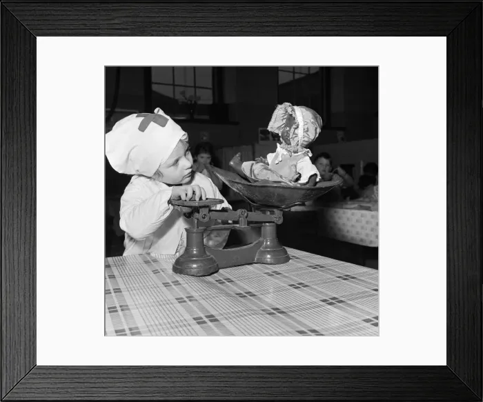 Framed Print : Rosemary Street Nursery School, Bristol. Dollies are liable to put on weight alarmingly