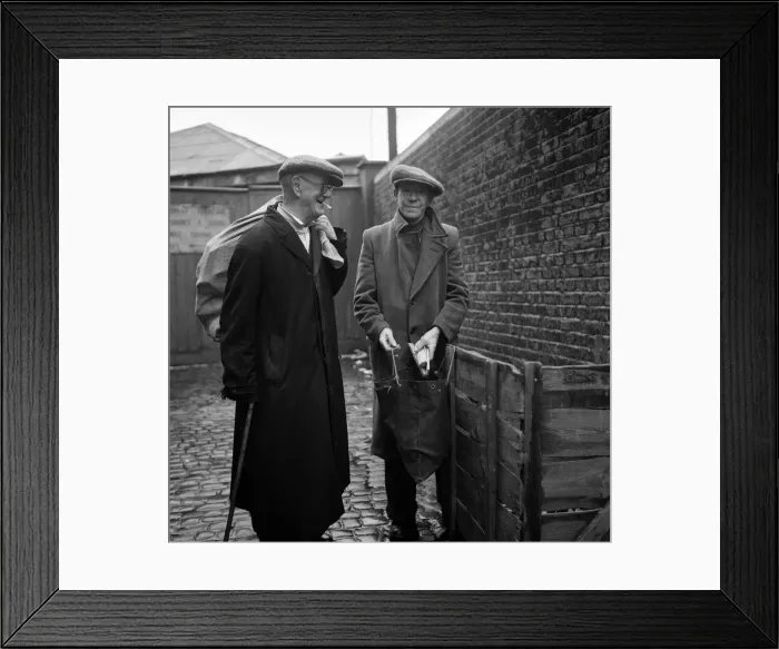 Framed Print : OAPs collecting firewood outside a furniture factory in Denmark Hill, London