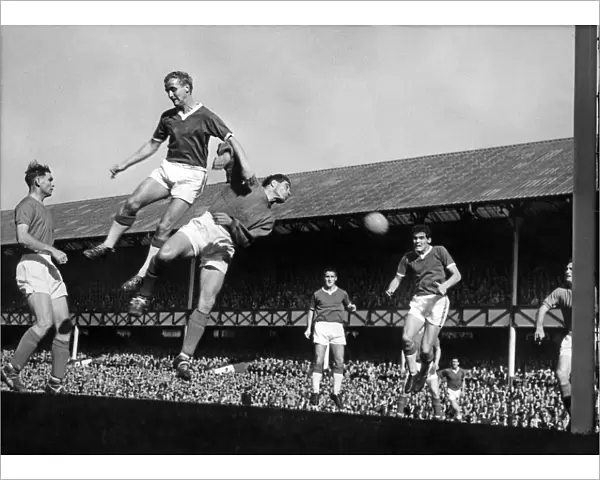 Everton footballer Alex Young and Ipswich goalkeeper Hall go up for a corner kick