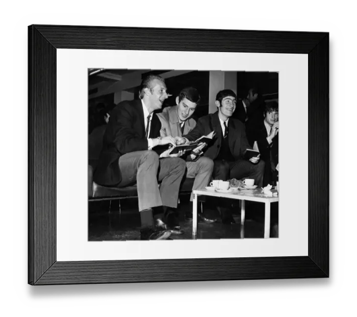 Framed Print : Manchester United footballer Denis Law (left) has a good laugh at the passport picture of Framed Print : Manchester United footballer Denis Law (left) has a good laugh at the passport picture of