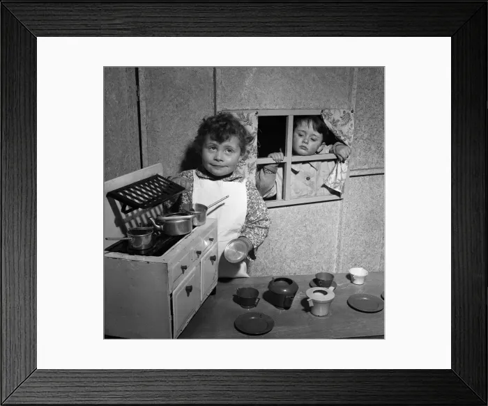 Framed Print : Four-year-old David McKnight and Jane Mathieson playing with their toy kitchen Framed Print : Four-year-old David McKnight and Jane Mathieson playing with their toy kitchen