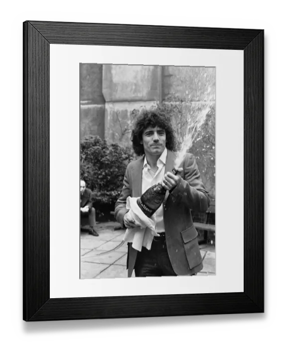 Framed Print : England footballer Kevin Keegan poses for photographers holding a large champagne bottle Framed Print : England footballer Kevin Keegan poses for photographers holding a large champagne bottle