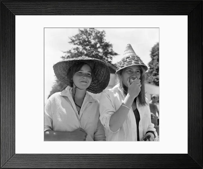 Framed Print : Roehampton swimming pool, London. These two young women with continental straw hats are Framed Print : Roehampton swimming pool, London. These two young women with continental straw hats are