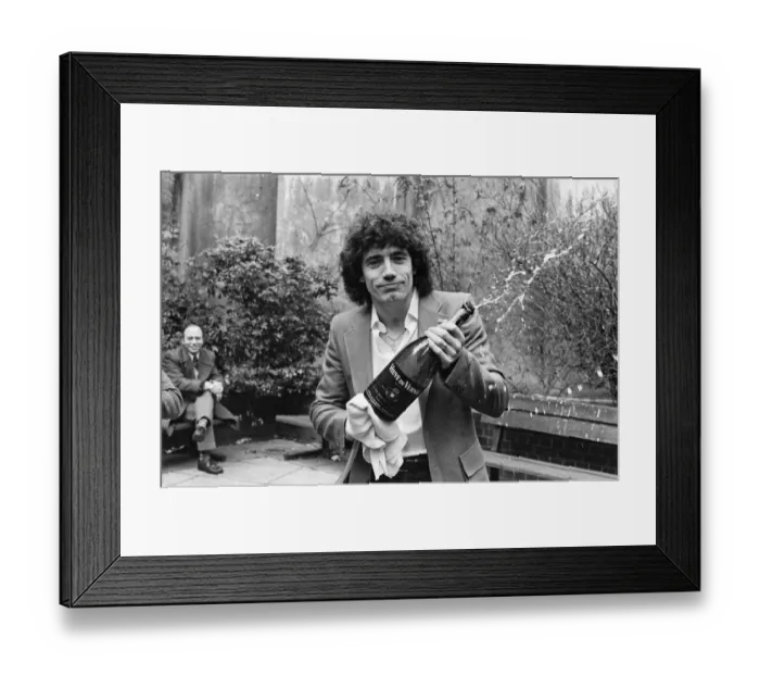 Framed Print : England footballer Kevin Keegan poses for photographers holding a large champagne bottle