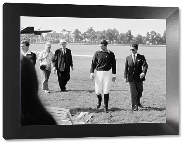 Picture shows Prince Charles (left) leaving the polo field with his friend