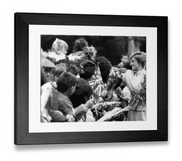 Framed Print : HRH Princess Diana, The Princess of Wales reaches out to take a bouquet from a little