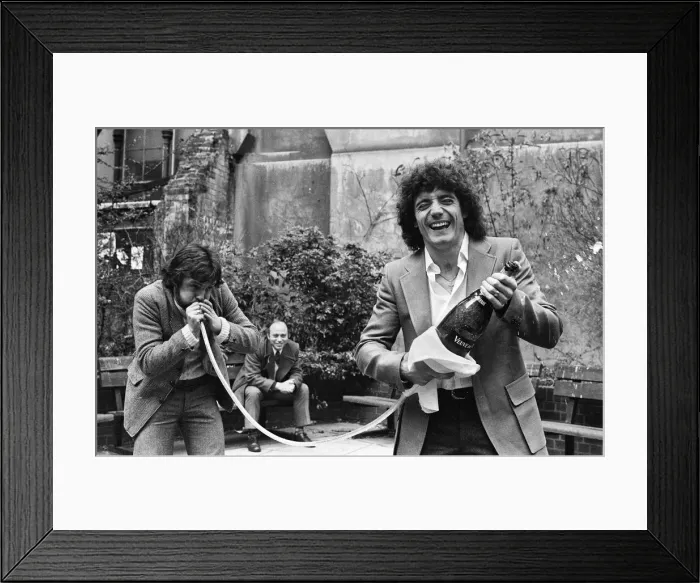 Framed Print : England footballer Kevin Keegan poses for photographers holding a large champagne bottle