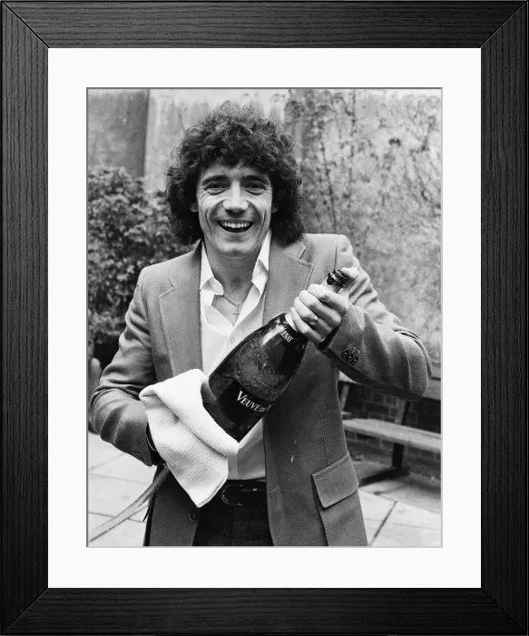 Framed Print : England footballer Kevin Keegan poses for photographers holding a large champagne bottle