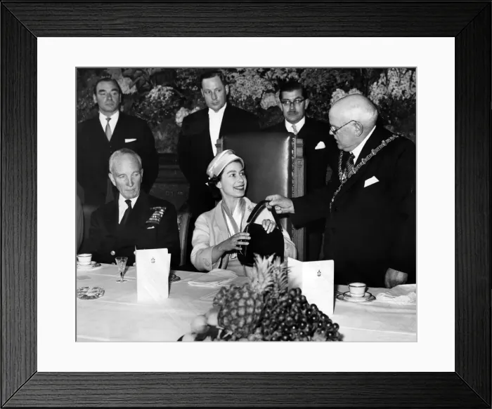 Framed Print : The Mayor of Dudley presents the Queen with a black leather handbag during her visit to Framed Print : The Mayor of Dudley presents the Queen with a black leather handbag during her visit to