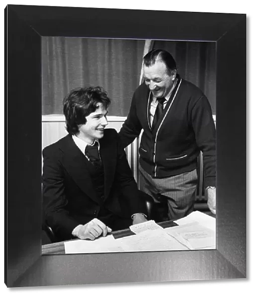 Liverpool manager Bob Paisley looks on as new defender Alan Hansen officially signs for