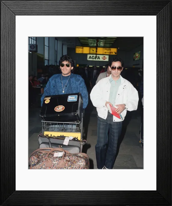 Framed Print : Argentina footballers Diego Maradona is met by his friend Framed Print : Argentina footballers Diego Maradona is met by his friend