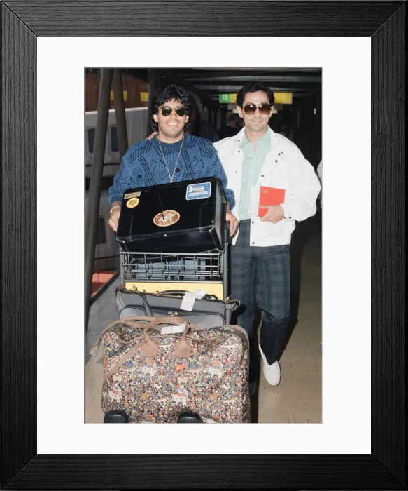 Framed Print : Argentina footballers Diego Maradona is met by his friend