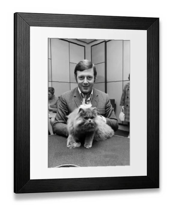 Framed Print : BBC commentator Michael Aspel at the BBC Studios at Lancaster Gate with a cat who is a Framed Print : BBC commentator Michael Aspel at the BBC Studios at Lancaster Gate with a cat who is a