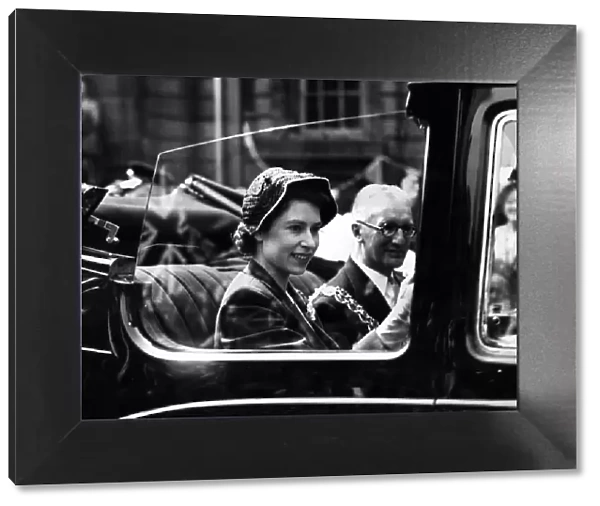 Princess Elizabeth smiles at the crowds along the route during her visit to the West