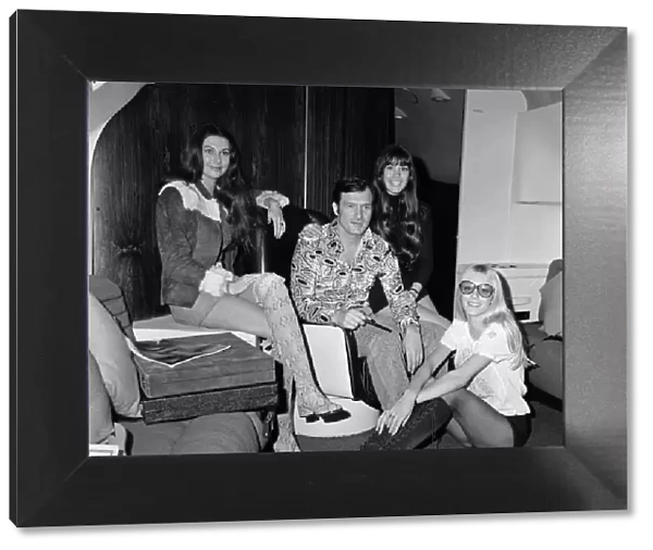 Hugh Hefner pictured in the Playboy Jet with, left to right, Marilyn Cole
