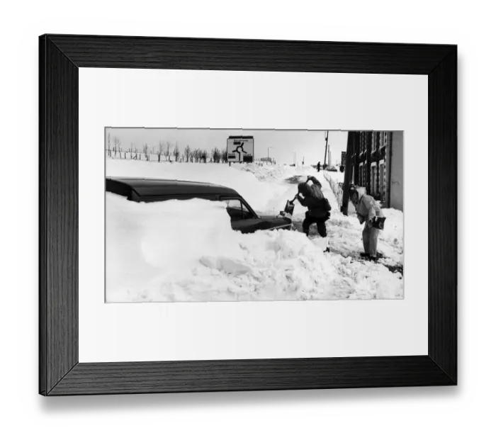 Framed Print : Workmen dig out a van from the blocked High Street, Dowlais. 27th April 1981