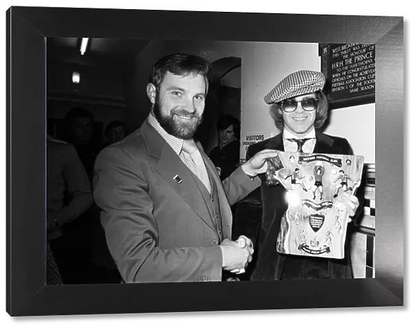 Musician and Watford FC chairman Elton John is presented with a special Jubilee plaque