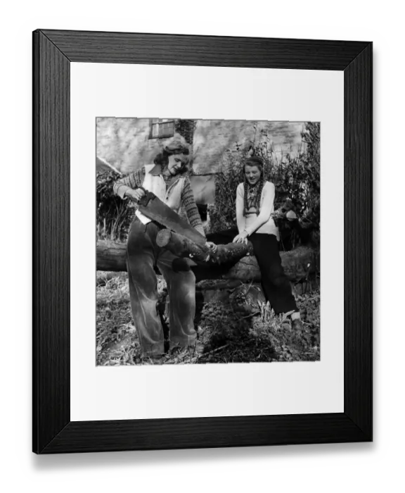 Framed Print : Daphne du Maurier and her daughter Tessa. Sawing wood Framed Print : Daphne du Maurier and her daughter Tessa. Sawing wood