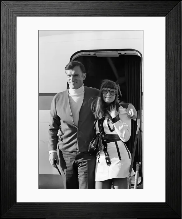 Framed Print : Hugh Hefner arriving at Gatwick Airport with his girlfriend Barbara Benton Framed Print : Hugh Hefner arriving at Gatwick Airport with his girlfriend Barbara Benton