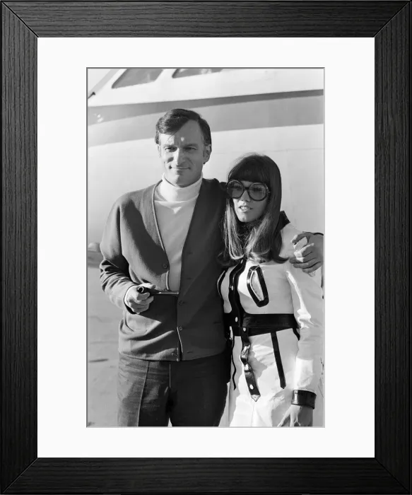 Framed Print : Hugh Hefner arriving at Gatwick Airport with his girlfriend Barbara Benton Framed Print : Hugh Hefner arriving at Gatwick Airport with his girlfriend Barbara Benton