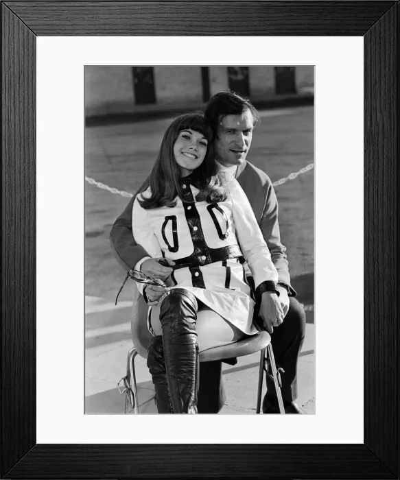 Framed Print : Hugh Hefner arriving at Gatwick Airport with his girlfriend Barbara Benton