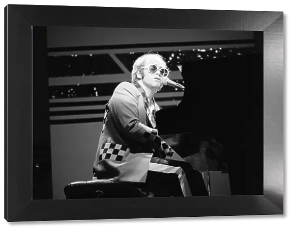 Elton John performing on stage, during the Elton John and Ray Cooper concert tours