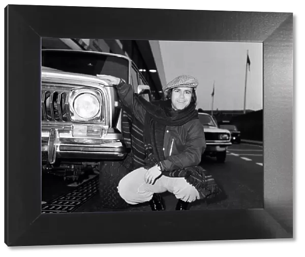 Elton John pictured next to an American Jeep at London Airport. February 1979