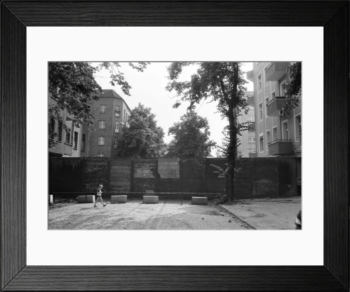 Framed Print : The Berlin Wall. The wall running into houses on either side of the road Framed Print : The Berlin Wall. The wall running into houses on either side of the road