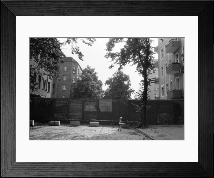 Framed Print : The Berlin Wall. The wall running into houses on either side of the road Framed Print : The Berlin Wall. The wall running into houses on either side of the road