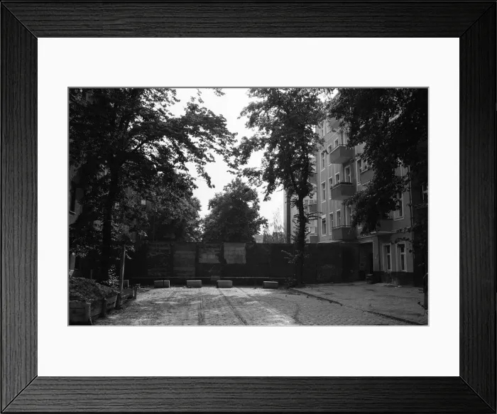 Framed Print : The Berlin Wall. The wall running into houses on either side of the road Framed Print : The Berlin Wall. The wall running into houses on either side of the road