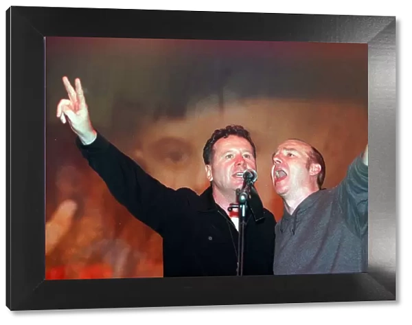 Jim Kerr of Simple Minds and Midge Ure May 1999 sing at the finale of the Scotland Rocks