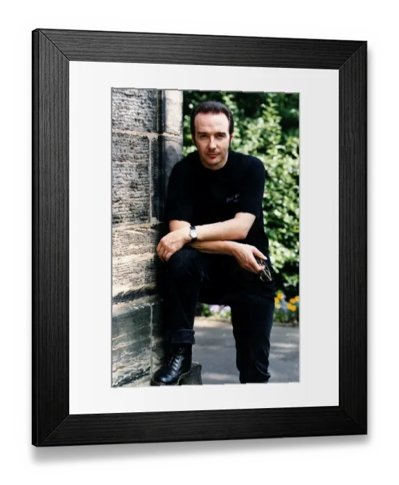 Framed Print : Midge Ure pop singer foot up arms on knee outside house black jeans T shirt