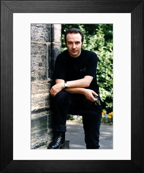 Framed Print : Midge Ure pop singer foot up arms on knee outside house black jeans T shirt Framed Print : Midge Ure pop singer foot up arms on knee outside house black jeans T shirt