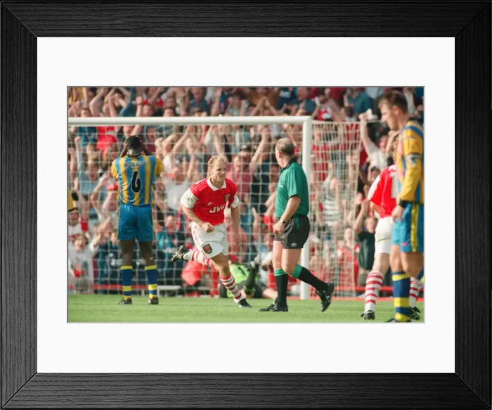 Framed Print : Dennis Bergkamp celebrates his second goal for his new club Arsenal