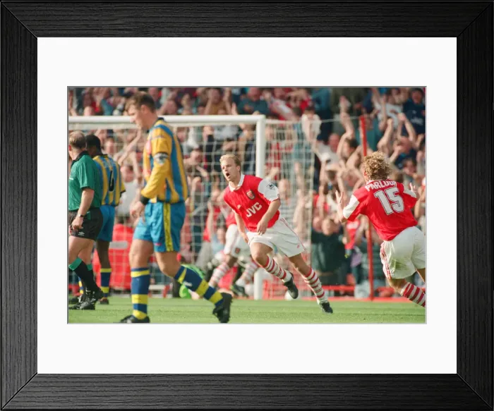 Framed Print : Dennis Bergkamp celebrates his second goal for his new club Arsenal