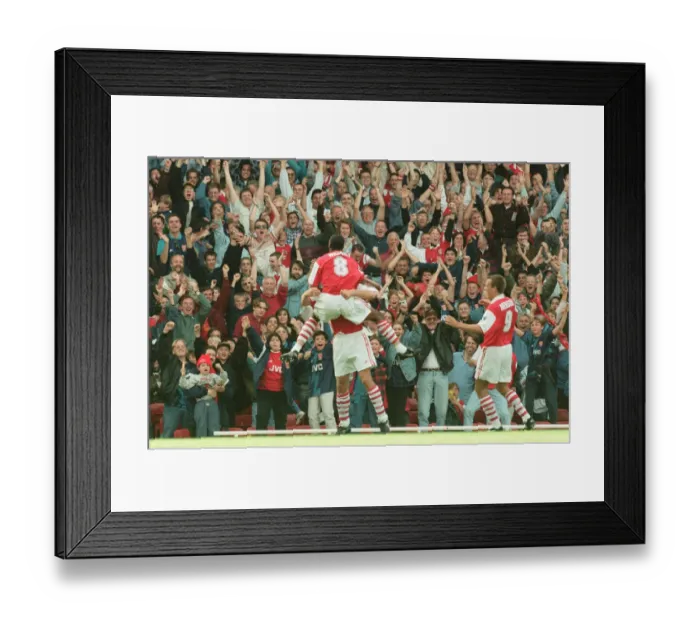Framed Print : Dennis Bergkamp celebrates his first ever goal for his new club Arsenal