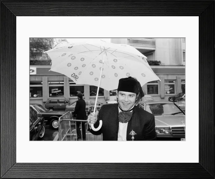 Framed Print : Elton John standing in the rain. He is in Montreux to perform at the Montreux Pop Framed Print : Elton John standing in the rain. He is in Montreux to perform at the Montreux Pop