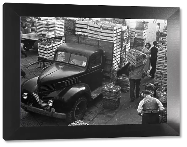 Fresh produce is off loaded at a Milan market. Circa 1955