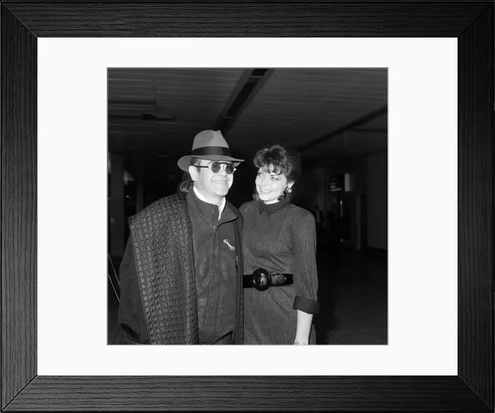 Framed Print : Elton John with his wife Renate arriving from Los Angeles at London Airport